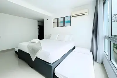 a white bedroom with a bed and a window at Apartamento 2 Dormitorios Morros. Salida playa in Cartagena de Indias