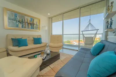 a living room with a couch and a table at Encanto Rentals at Sunno Beach in Cartagena de Indias