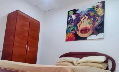 a bedroom with a bed and a painting on the wall at Cartagena más cómoda y económica in Cartagena de Indias