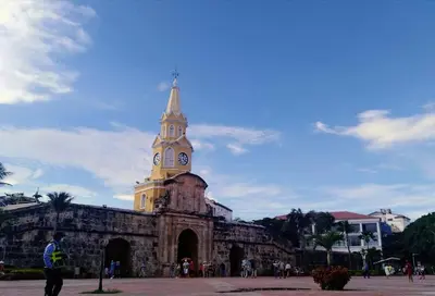 a building with a tower with a clock on it at Cartagena más cómoda y económica in Cartagena de Indias