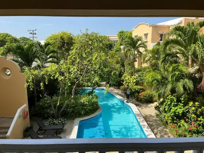 a view of a swimming pool from the balcony of a resort at by Calamari Homes - Parque Centenario 206 walled city in Cartagena de Indias