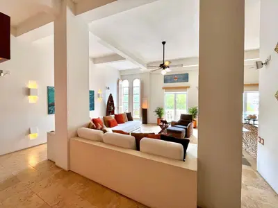 a living room with a couch and a table at by Calamari Homes - Parque Centenario 206 walled city in Cartagena de Indias