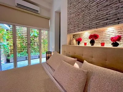 a living room with a couch and a brick wall at by Calamari Homes - Parque Centenario 206 walled city in Cartagena de Indias