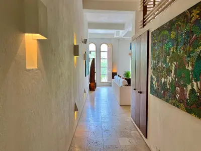 a hallway with a large painting on the wall at by Calamari Homes - Parque Centenario 206 walled city in Cartagena de Indias
