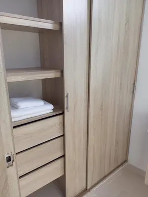 a closet with wooden cabinets and a mattress at Apartamentos Mi Reserva OK - Fontaine Bleu in Coveñas