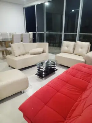 a living room with couches and a red couch at Apartamentos Mi Reserva OK - Fontaine Bleu in Coveñas