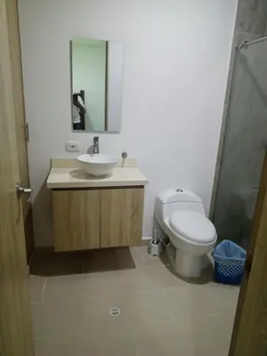 a bathroom with a toilet and a sink and a mirror at Apartamentos Mi Reserva OK - Fontaine Bleu in Coveñas