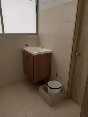 a bathroom with a toilet and a sink and a window at Apartamentos Mi Reserva OK - Fontaine Bleu in Coveñas