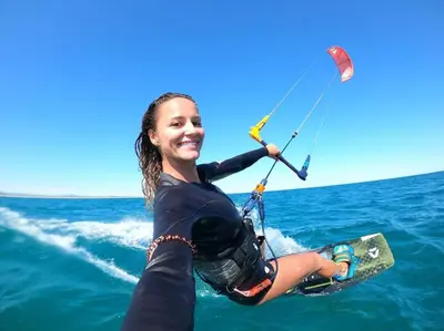a girl in the water on a wake board at Espectacular casa en oferta con piscina privada y vista al mar in Carretal