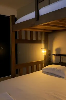a bedroom with two bunk beds and a lamp at Casa ALCATRAZ in Cartagena de Indias