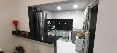 a kitchen with a black counter and a refrigerator at Habitación Cangrejo in Barranquilla