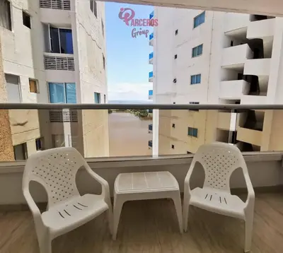 two white chairs sitting in front of a window at Edificio Las Tres Carabelas Por Parceros Group in Cartagena de Indias