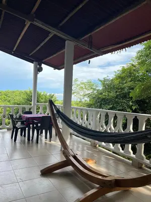 a hammock on the porch of a house at Casa Majanicho in Rincón