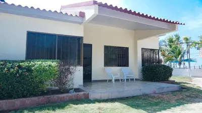 two chairs in front of a house at Cabaña La Pereztroica 1 in Coveñitas