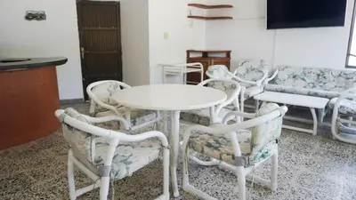 a room with a table and chairs and a couch at Cabaña La Pereztroica 1 in Coveñitas