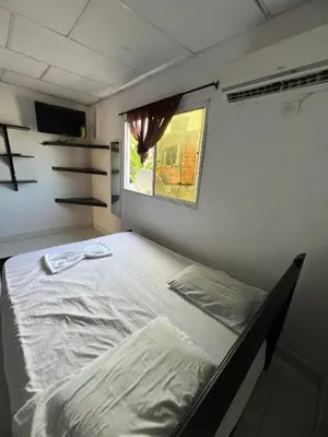 a bed in a small room with a window at Apartamentos Coveñas TII in Coveñas