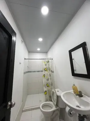 a bathroom with a toilet and a sink and a shower at Apartamentos Coveñas TII in Coveñas