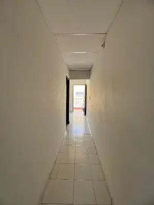 an empty hallway with white walls and a tile floor at Apartamentos Coveñas TII in Coveñas