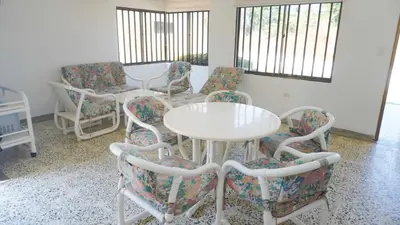 a room with chairs and a white table and chairs at Cabaña La Pereztroica 3 in Coveñitas