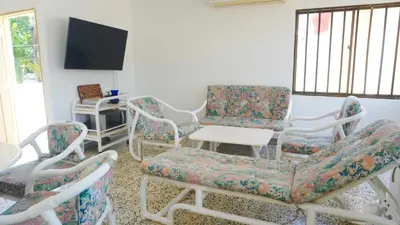 a living room with chairs and a table and a tv at Cabaña La Pereztroica 3 in Coveñitas