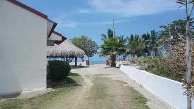 a house with a path next to a beach at Cabaña La Pereztroica 3 in Coveñitas