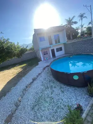 a large swimming pool in front of a house at Villa Carolina SM in Santa Marta