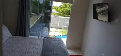 a bedroom with a bed and a large window at Villa Carolina SM in Santa Marta