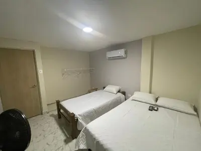 a hospital room with two beds and a fan at Villa Carolina SM in Santa Marta