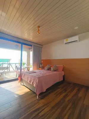 a bedroom with a bed and a large window at SUITE OCEAN VIEW - Playa in Tolú