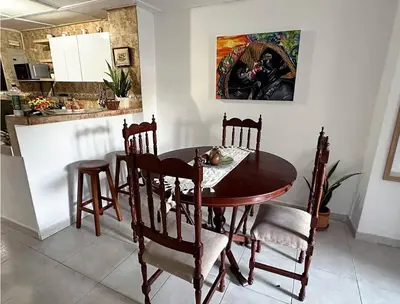 a dining room table and chairs in a kitchen at Great Location, Apartment Close to the Malecón in Barranquilla