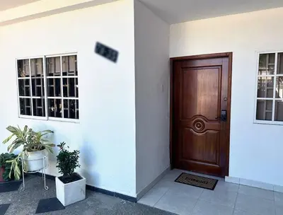 a wooden door in a building with two potted plants at Great Location, Apartment Close to the Malecón in Barranquilla
