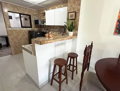 a kitchen with a counter and stools in a room at Great Location, Apartment Close to the Malecón in Barranquilla