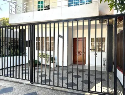 a black fence in front of a building with a door at Great Location, Apartment Close to the Malecón in Barranquilla