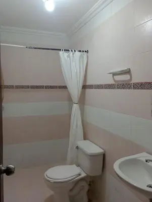 a bathroom with a toilet and a sink at Hostal Miami Beach in Cartagena de Indias