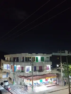 a white building with colorful windows at night at Hostal Miami Beach in Cartagena de Indias