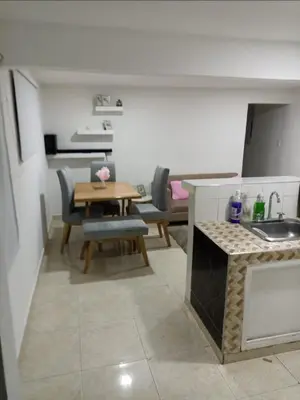a kitchen and a dining room with a table and a tablektop at Hermoso y cómodo apartamento in Cartagena de Indias