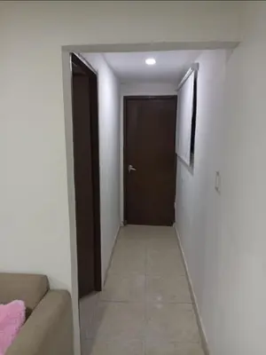 a hallway with a door and a couch in a room at Hermoso y cómodo apartamento in Cartagena de Indias