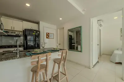 a kitchen with two bar stools and a counter top at Edificio Morros 3 in Cartagena de Indias