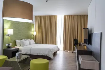 a hotel room with a bed and a television at Holiday Inn Express - Cartagena Bocagrande by IHG in Cartagena de Indias