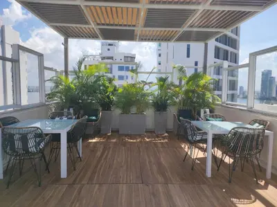 a balcony with two tables and chairs and plants at Holiday Inn Express - Cartagena Bocagrande by IHG in Cartagena de Indias