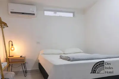 a small bedroom with a bed and a window at DES INDES CARTAGENA in Cartagena de Indias