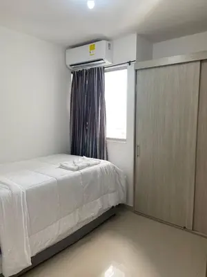 a small bedroom with a bed and a window at Apartamento Cerca Playa Marbella in Cartagena de Indias