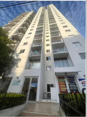 a tall white building with balconies on it at Apartamento Cerca Playa Marbella in Cartagena de Indias