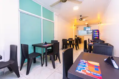 a dining room with black tables and chairs at Hotel Med Cartagena in Cartagena de Indias