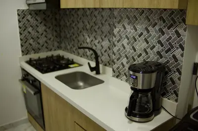 a kitchen with a coffeemaker on a counter next to a sink at Great location close to airport in Cartagena de Indias