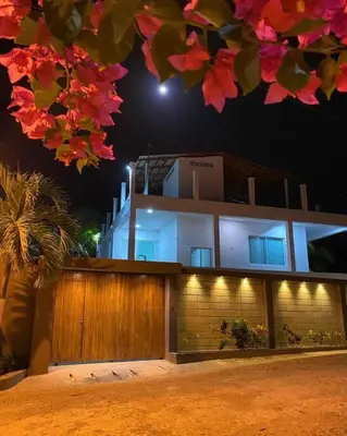 a building is lit up at night at Palma House - Cabaña con piscina in Tubará