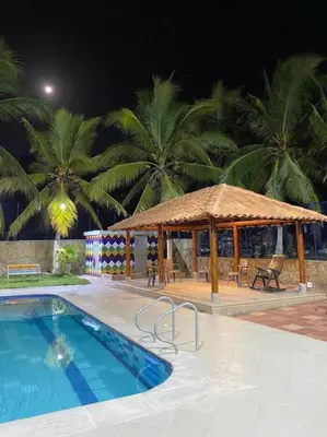 a swimming pool with a gazebo and a swimming pool at Palma House - Cabaña con piscina in Tubará