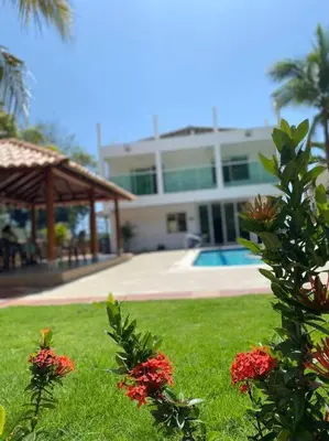 a house with a yard with flowers in the grass at Palma House - Cabaña con piscina in Tubará