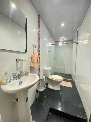 a bathroom with a sink and a toilet at Palma House - Cabaña con piscina in Tubará