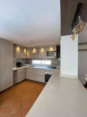 a kitchen with a white counter and a white refrigerator at Palma House - Cabaña con piscina in Tubará